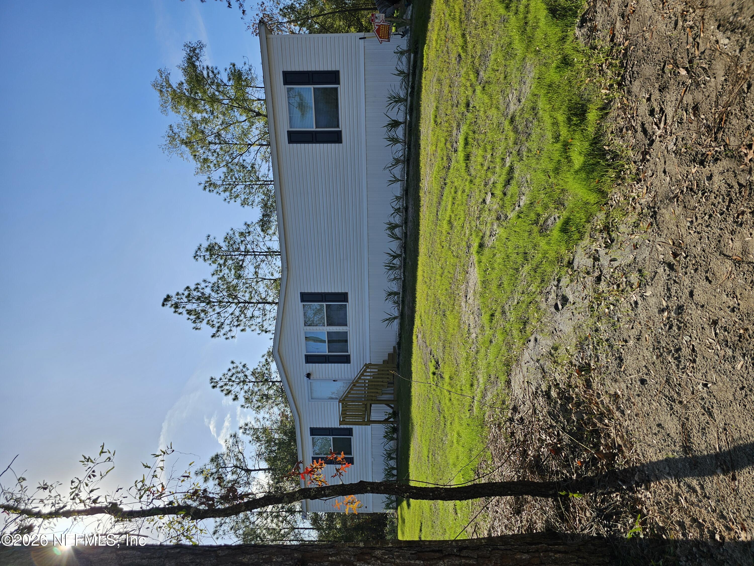 a view of a house with a yard