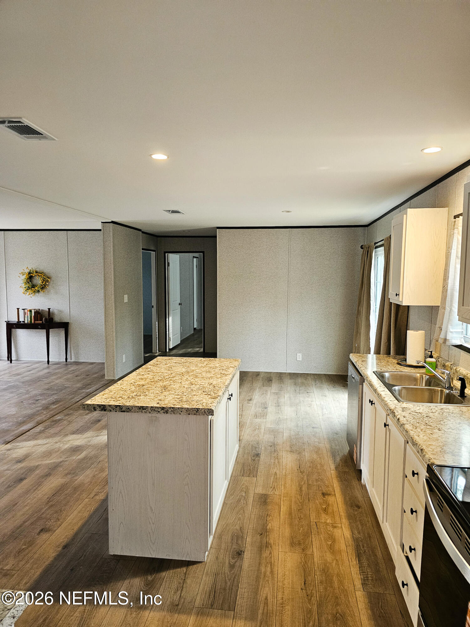 295 Baden Powell Road Hawthorne, FL 32640 - Photo 11 of 15 a kitchen with stainless steel appliances granite countertop a stove a sink and a refrigerator