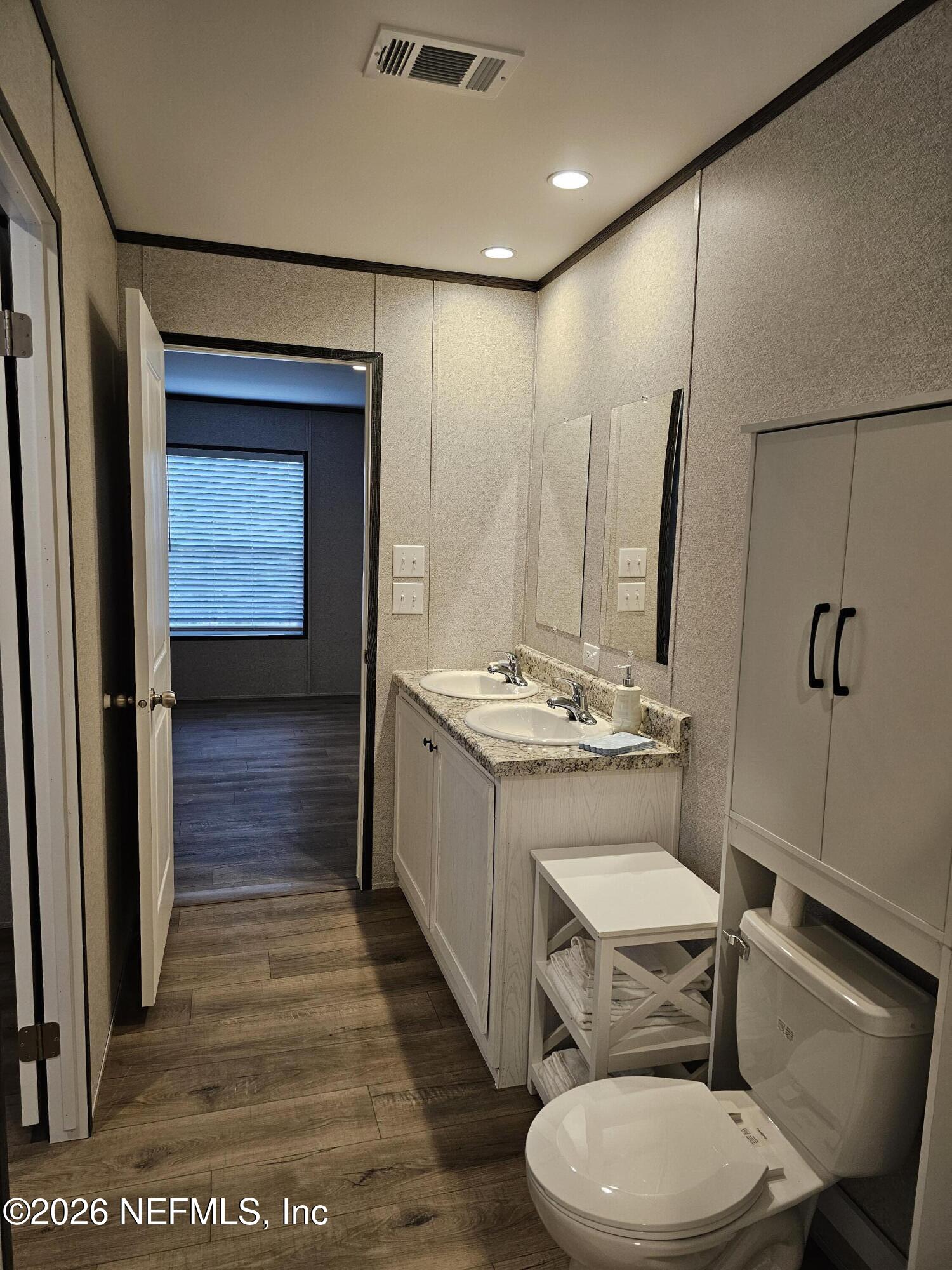 295 Baden Powell Road Hawthorne, FL 32640 - Photo 13 of 15 a bathroom with a sink a toilet and mirror