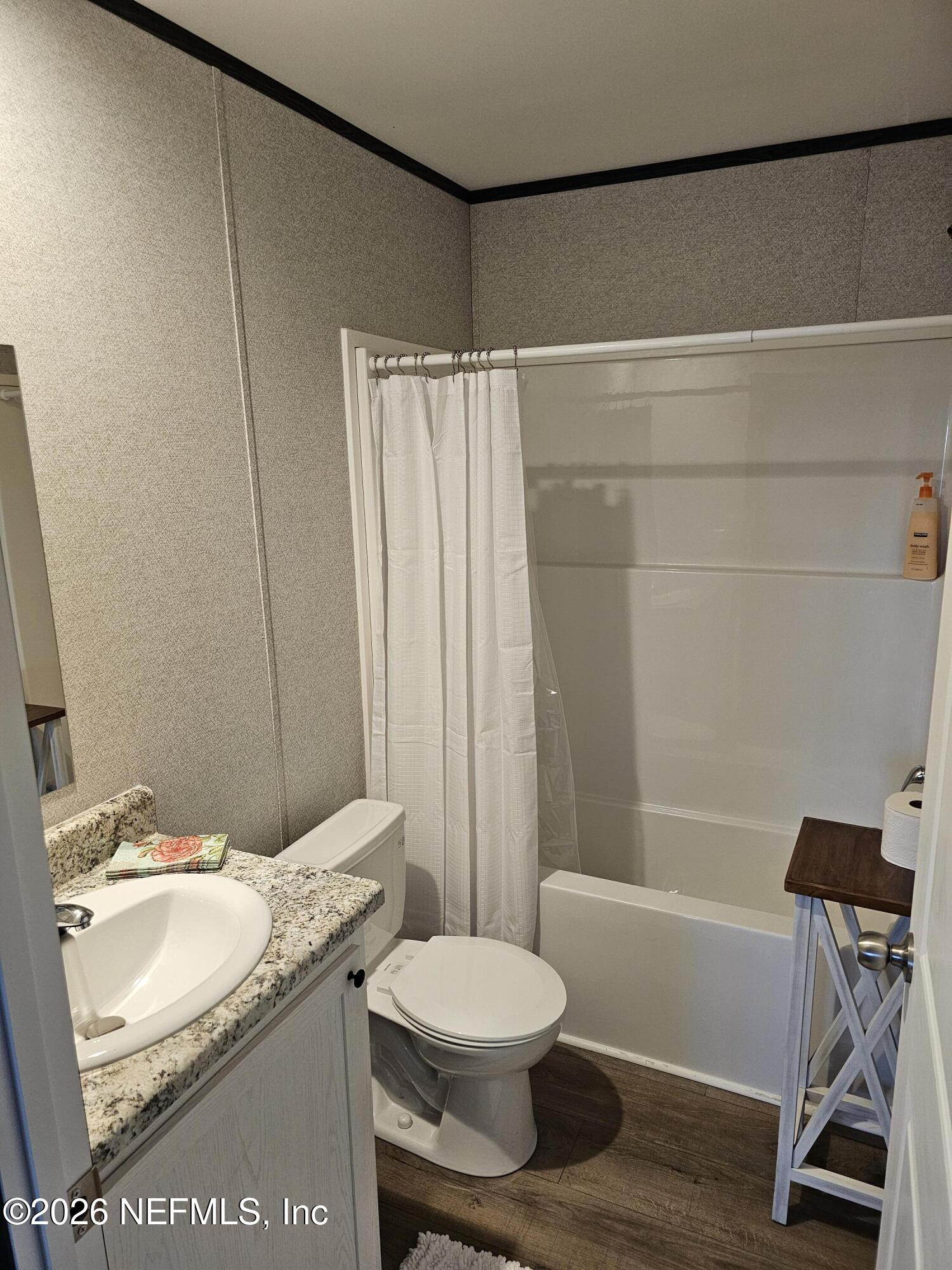 295 Baden Powell Road Hawthorne, FL 32640 - Photo 14 of 15 a bathroom with a granite countertop sink toilet and shower