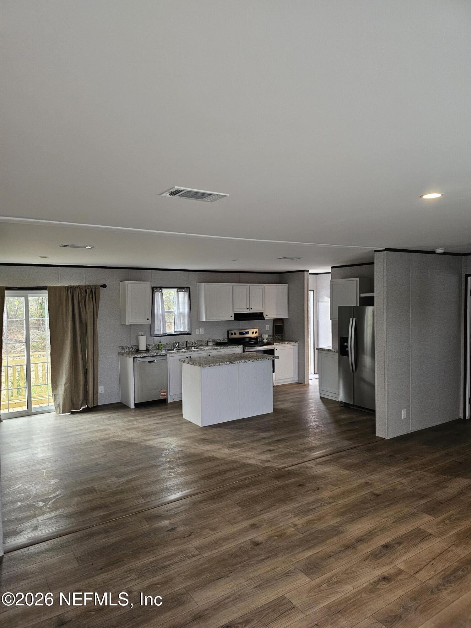 295 Baden Powell Road Hawthorne, FL 32640 - Photo 8 of 15 a view of kitchen with microwave refrigerator and cabinets
