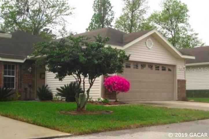 4717 Northwest 76th Road Gainesville, FL 32653 - Photo 1 of 1 a front view of a house with garden