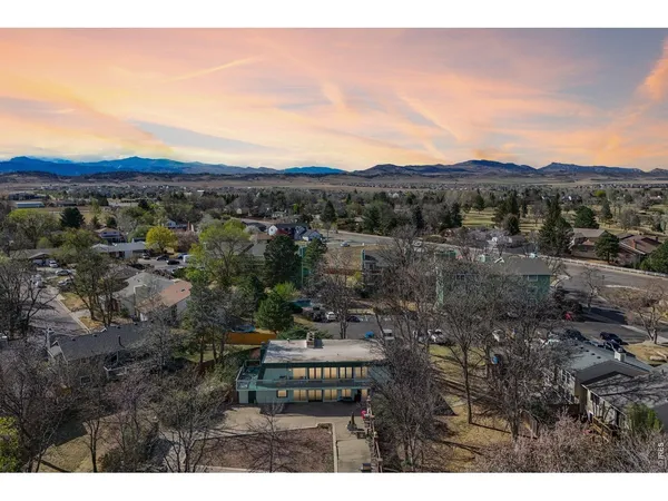 a view of a city with lush green forest