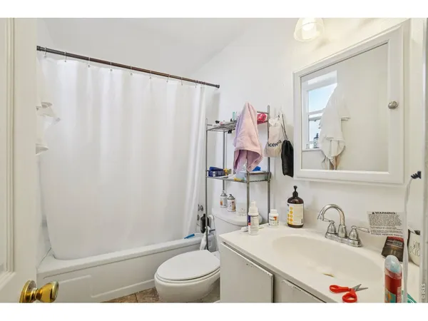a bathroom with a sink vanity mirror and toilet