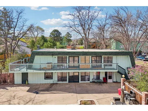 a view of a house with a garden and pathway