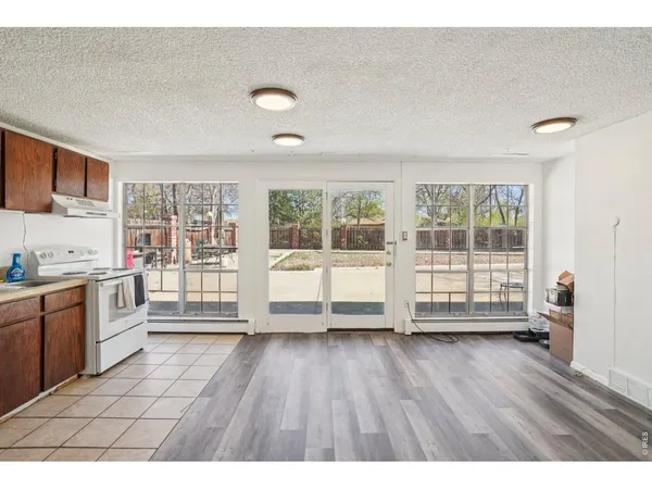 a view of wooden floor and windows in a room