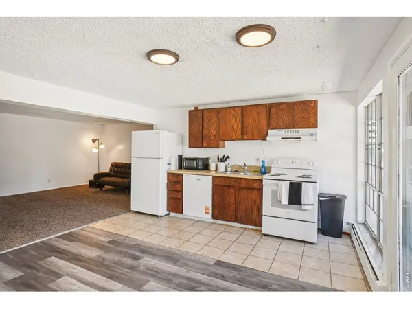 a kitchen with a refrigerator and a stove top oven