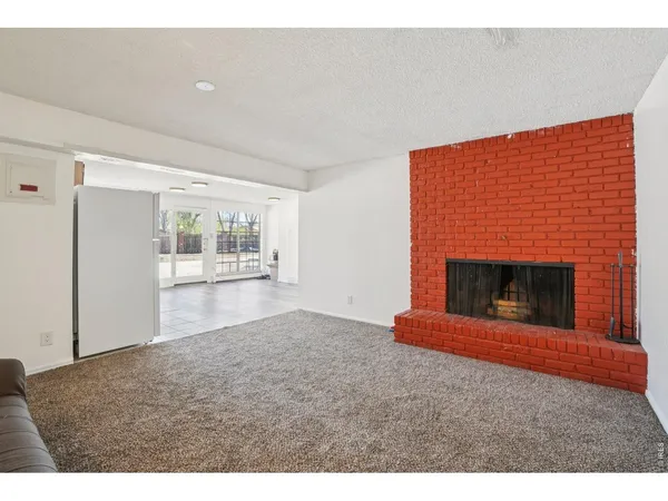 a view of empty room with a fireplace