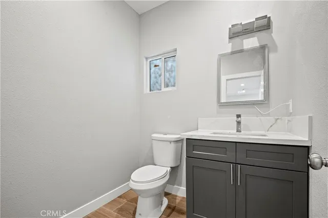 a bathroom with a toilet a sink and mirror