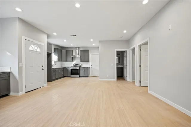 a view of an empty room with a cabinet and a window
