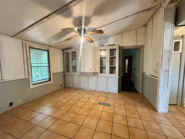 a view of a hallway to room with windows