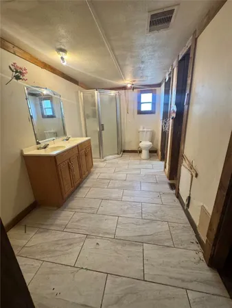 a view of a hallway with entryway window and front door