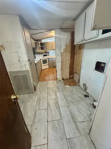 a view of a kitchen with storage and utility