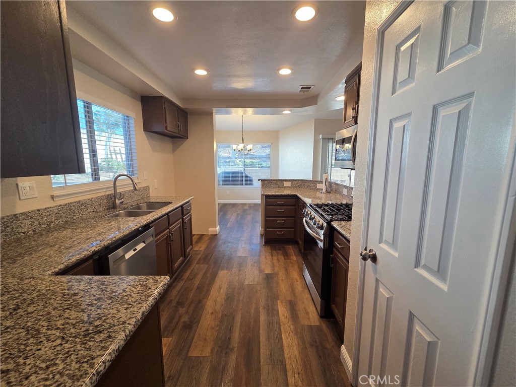 730 Black Oak Circle Corona, CA 92881 - Photo 3 of 7 a kitchen with stainless steel appliances granite countertop sink stove and refrigerator
