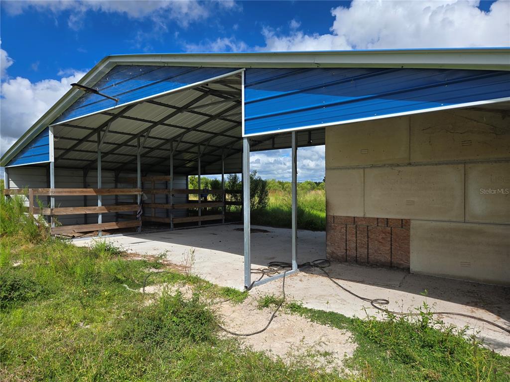 Southeast Piggy Back Road Arcadia, FL 34266 - Photo 3 of 5 a backyard of a house with barbeque oven table and chairs