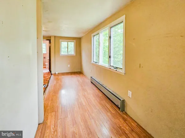 a view of a room with wooden floor and window