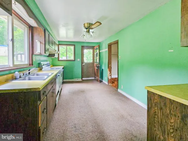a spacious bathroom with a granite countertop sink a large mirror and a bathtub