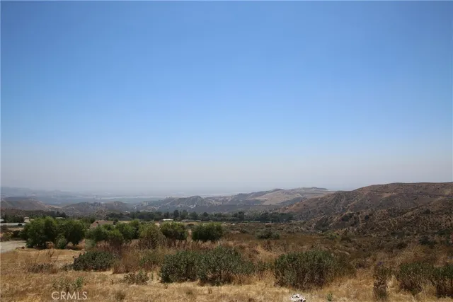 an aerial view of a residential houses with city view and mountain view