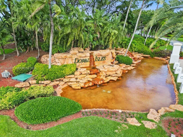 a living room with furniture kitchen view and a wooden floor