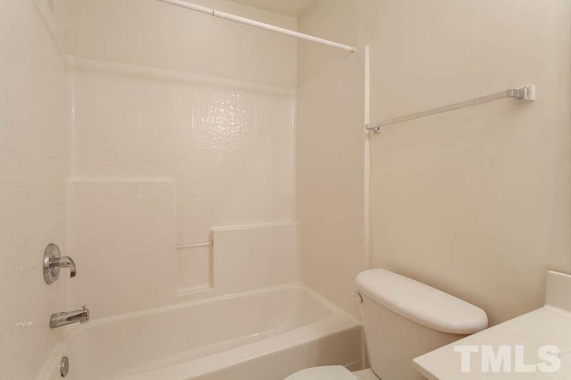 4904 Tommans Trail Raleigh, NC 27616 - Photo 14 of 20 a bathroom with a bathtub and a toilet