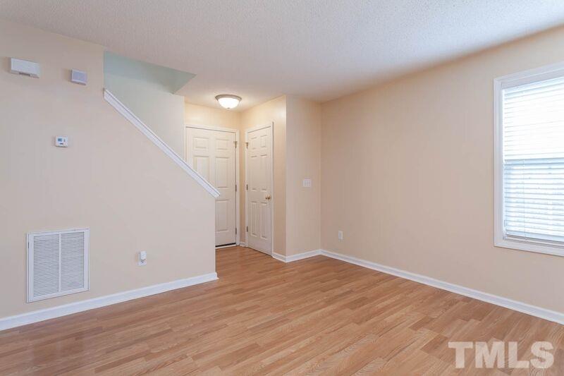4904 Tommans Trail Raleigh, NC 27616 - Photo 3 of 20 a view of an empty room with wooden floor and a window