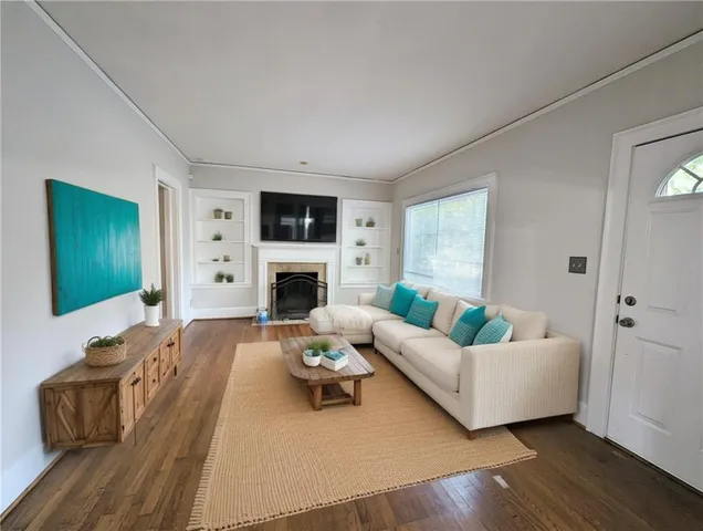 a living room with furniture fireplace and a flat screen tv