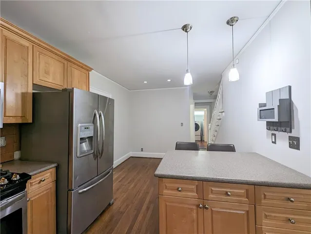 a kitchen with a refrigerator a sink and cabinets
