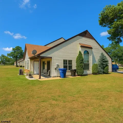 a view of a house with patio and garden