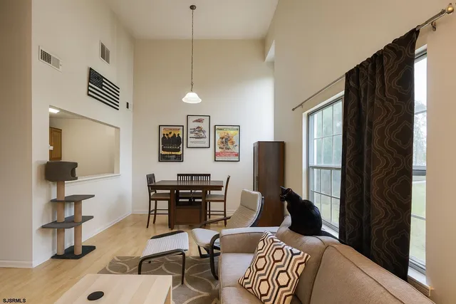 a living room with furniture a desk and chair with wooden floor