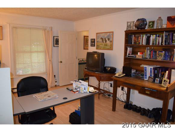 739 Cattle Scales Road Waynesboro, VA 22980 - Photo 15 of 36 a view of a workspace with a bookshelf and a window