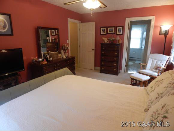 739 Cattle Scales Road Waynesboro, VA 22980 - Photo 19 of 36 a bedroom with a bed and a flat tv screen on dresser