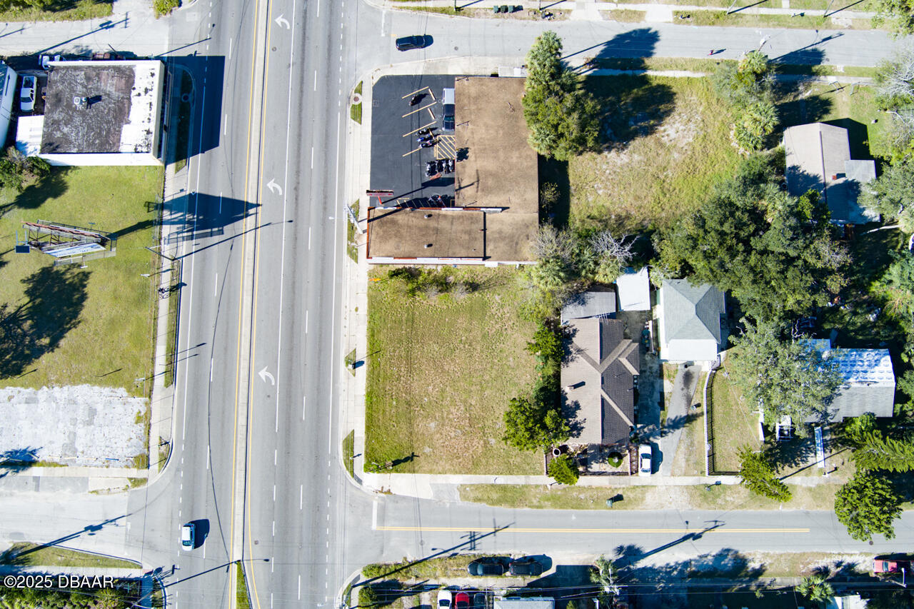 0 North Ridgewood Avenue Daytona Beach, FL 32114 - Photo 3 of 7 an aerial view of residential houses with outdoor space and parking