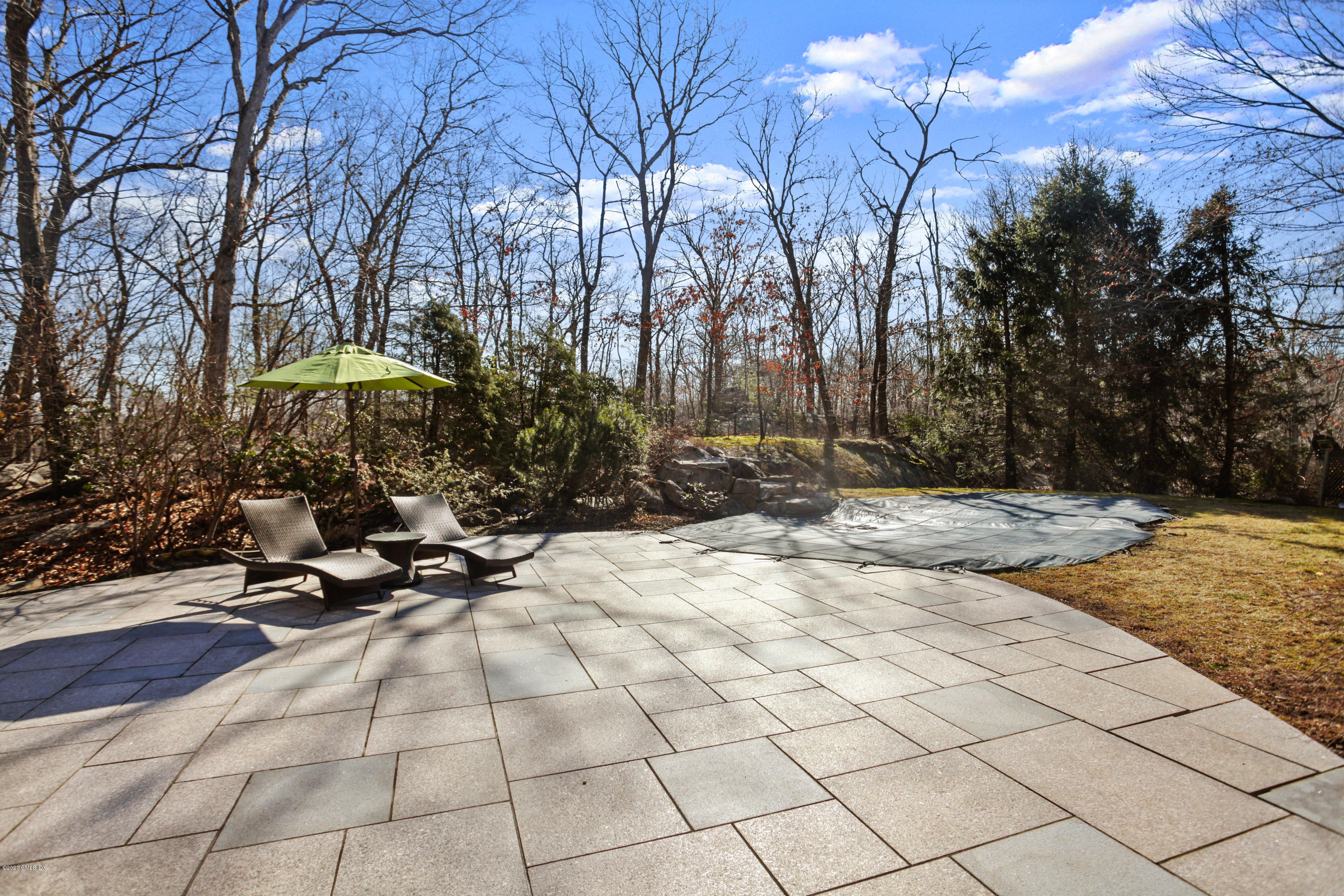 31 Horseshoe Road Cos Cob, CT 06807 - Photo 27 of 34 stone terrace with chairs pool