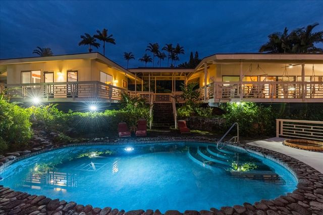 an aerial view of a house with a garden and lake view