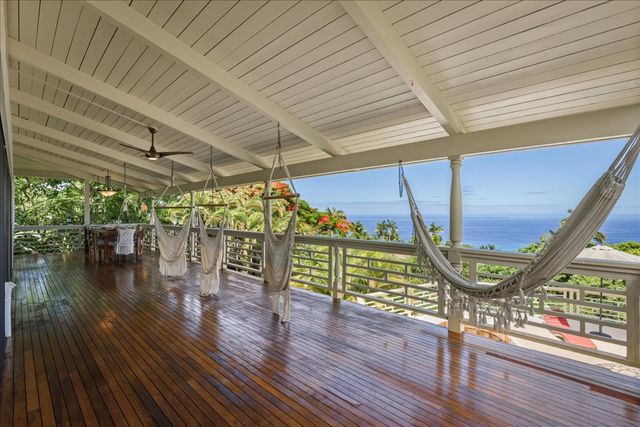 a view of a patio with dining table and chairs with wooden floor