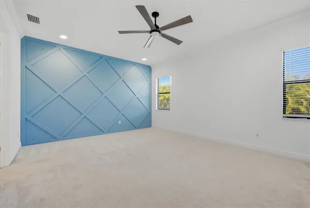 a view of a livingroom with a ceiling fan and window