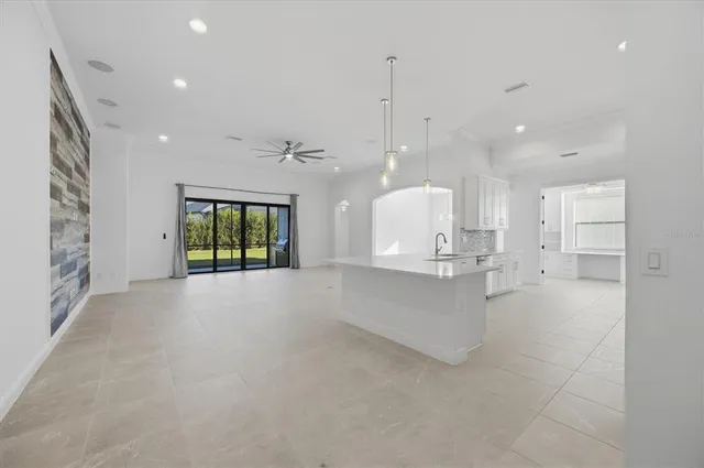 a view of a kitchen with large windows