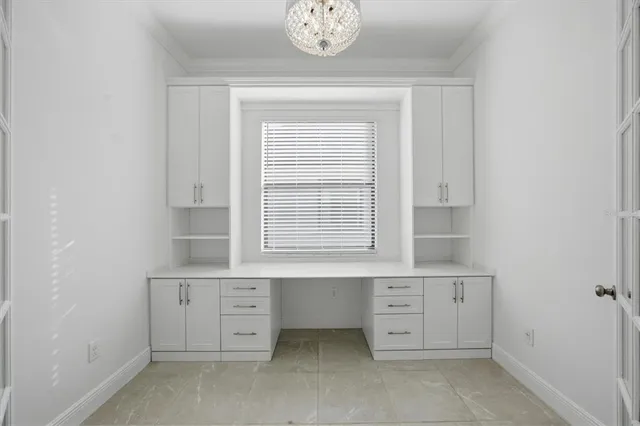 a view of cabinets a sink and a stove in a room