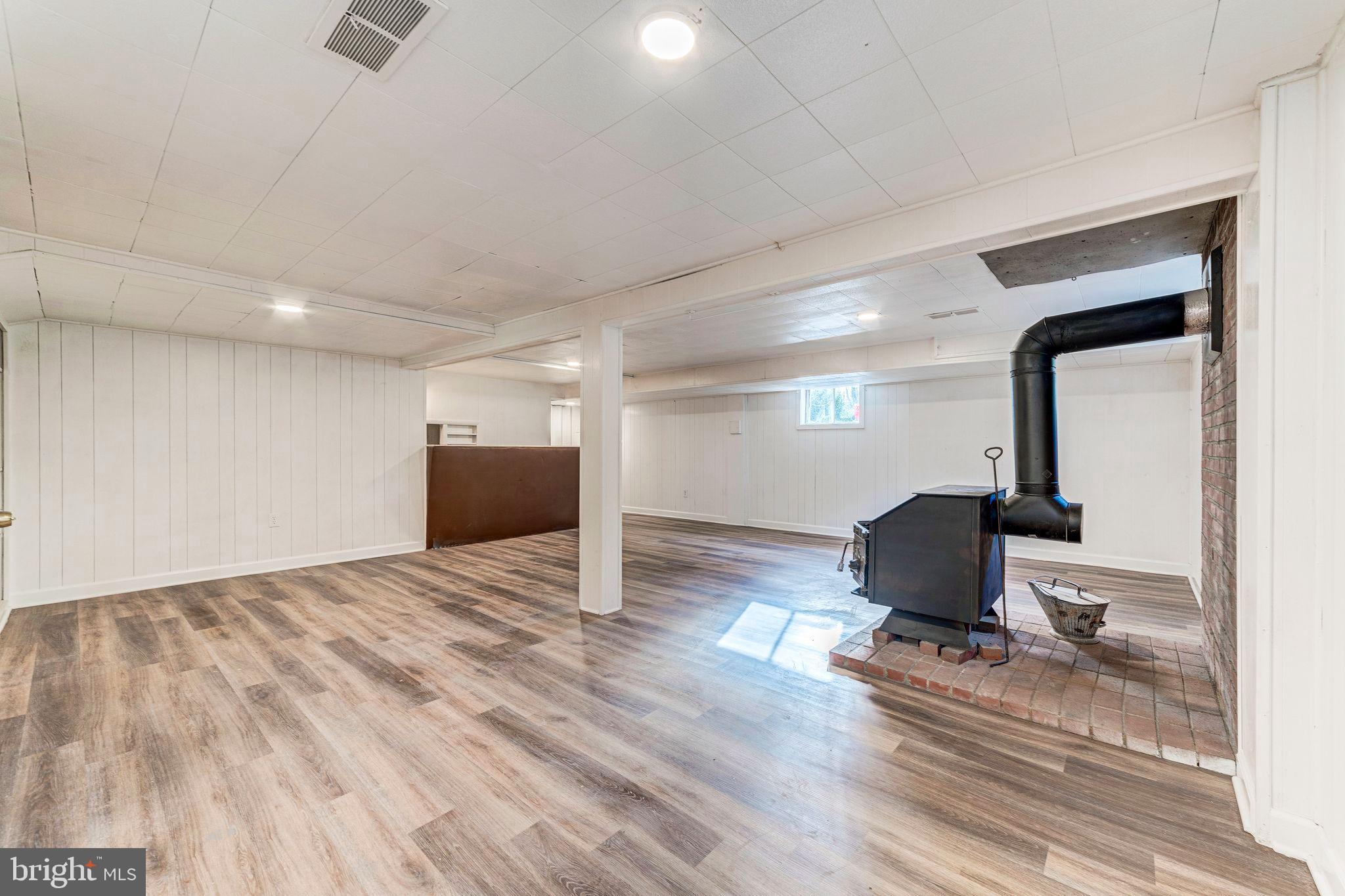 7219 Tanager Street Springfield, VA 22150 - Photo 40 of 55 Lower Level Rec Room with Wood Burning Stove