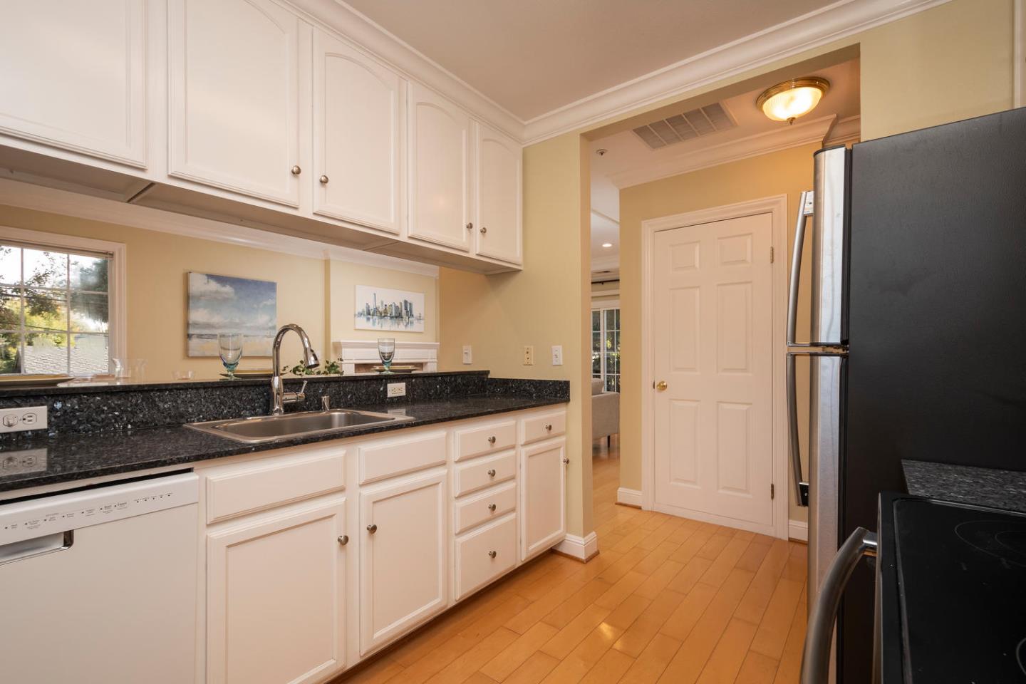 914 Palm Avenue San Mateo, CA 94401 - Photo 22 of 24 a kitchen with granite countertop white cabinets and stainless steel appliances
