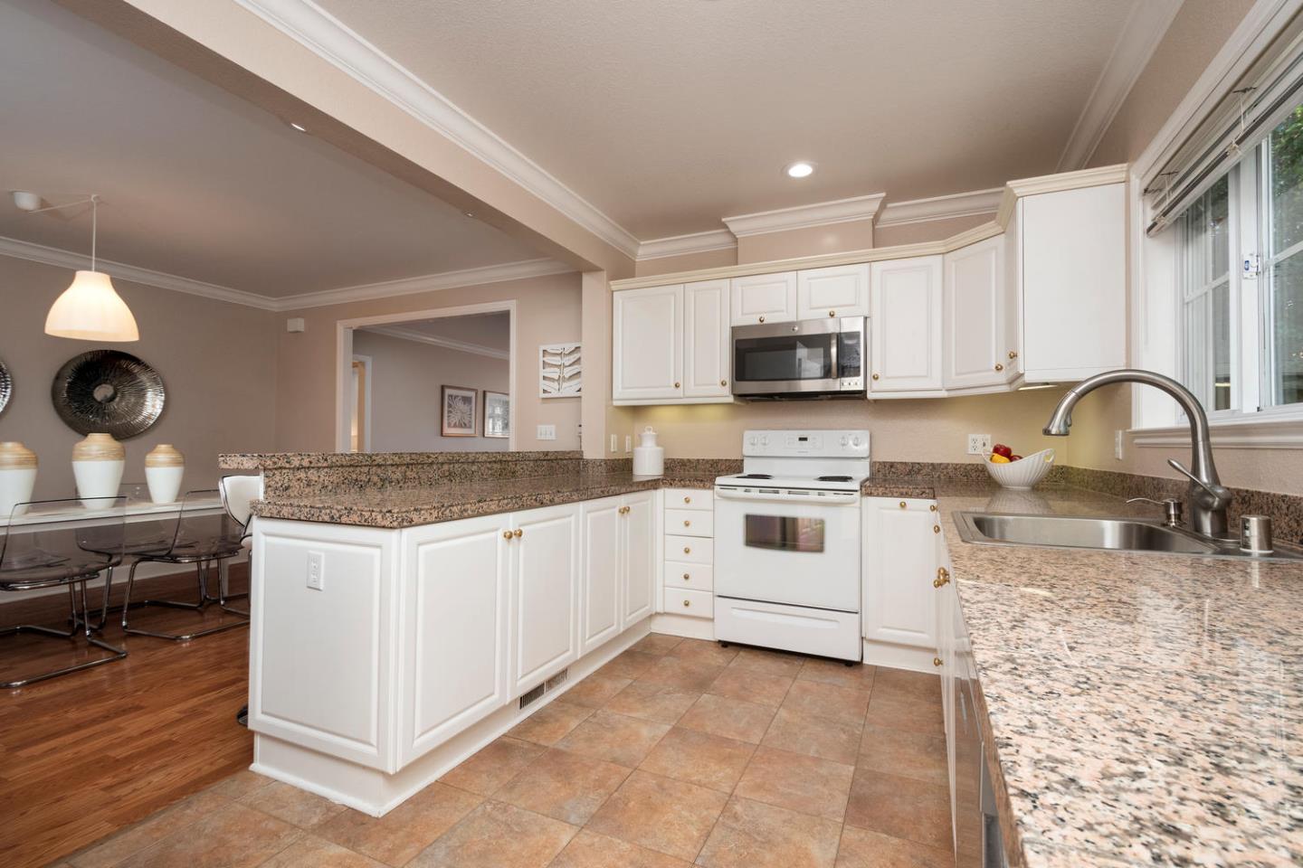 914 Palm Avenue San Mateo, CA 94401 - Photo 9 of 24 a kitchen with granite countertop a stove sink and cabinets