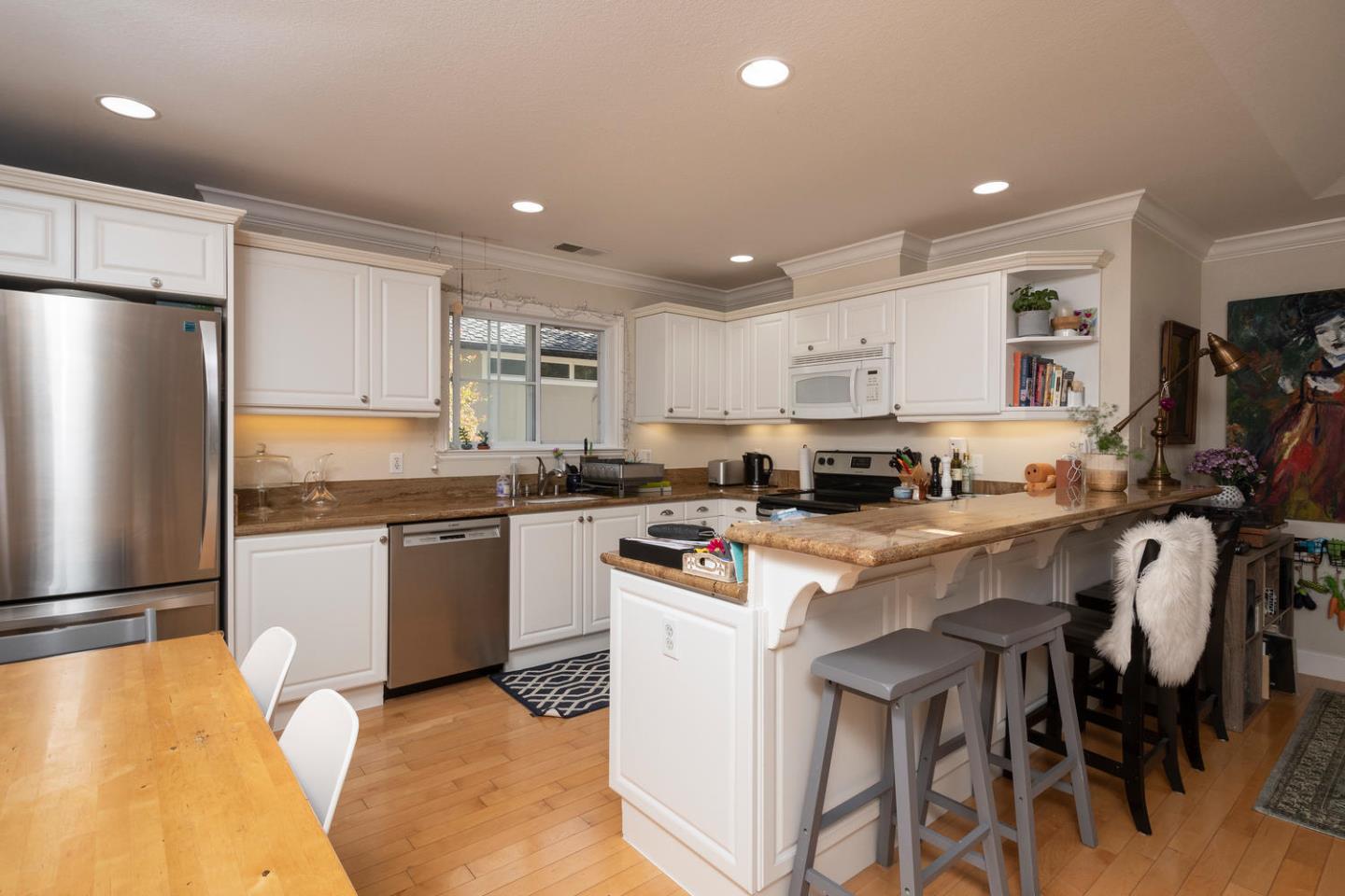 914 Palm Avenue San Mateo, CA 94401 - Photo 10 of 24 a kitchen with a sink stainless steel appliances and white cabinets