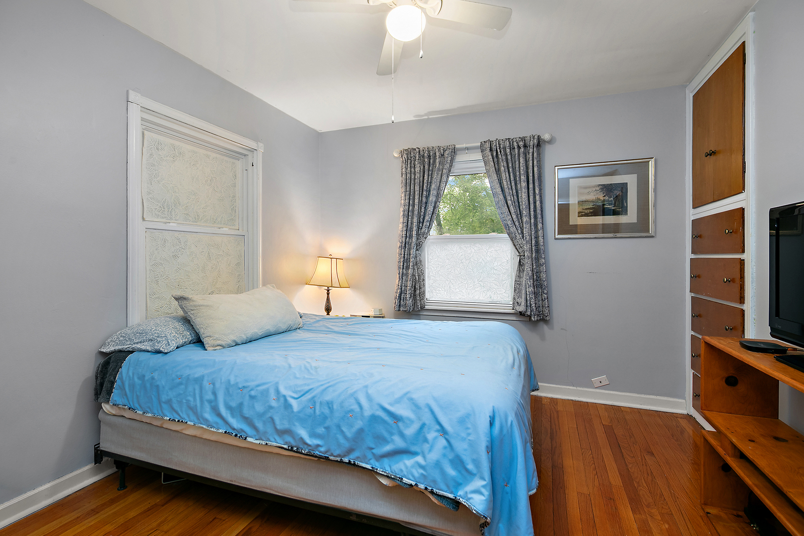2444 183rd Street Homewood, IL 60430 - Photo 13 of 25 a bedroom with a bed and a flat tv screen on a dresser