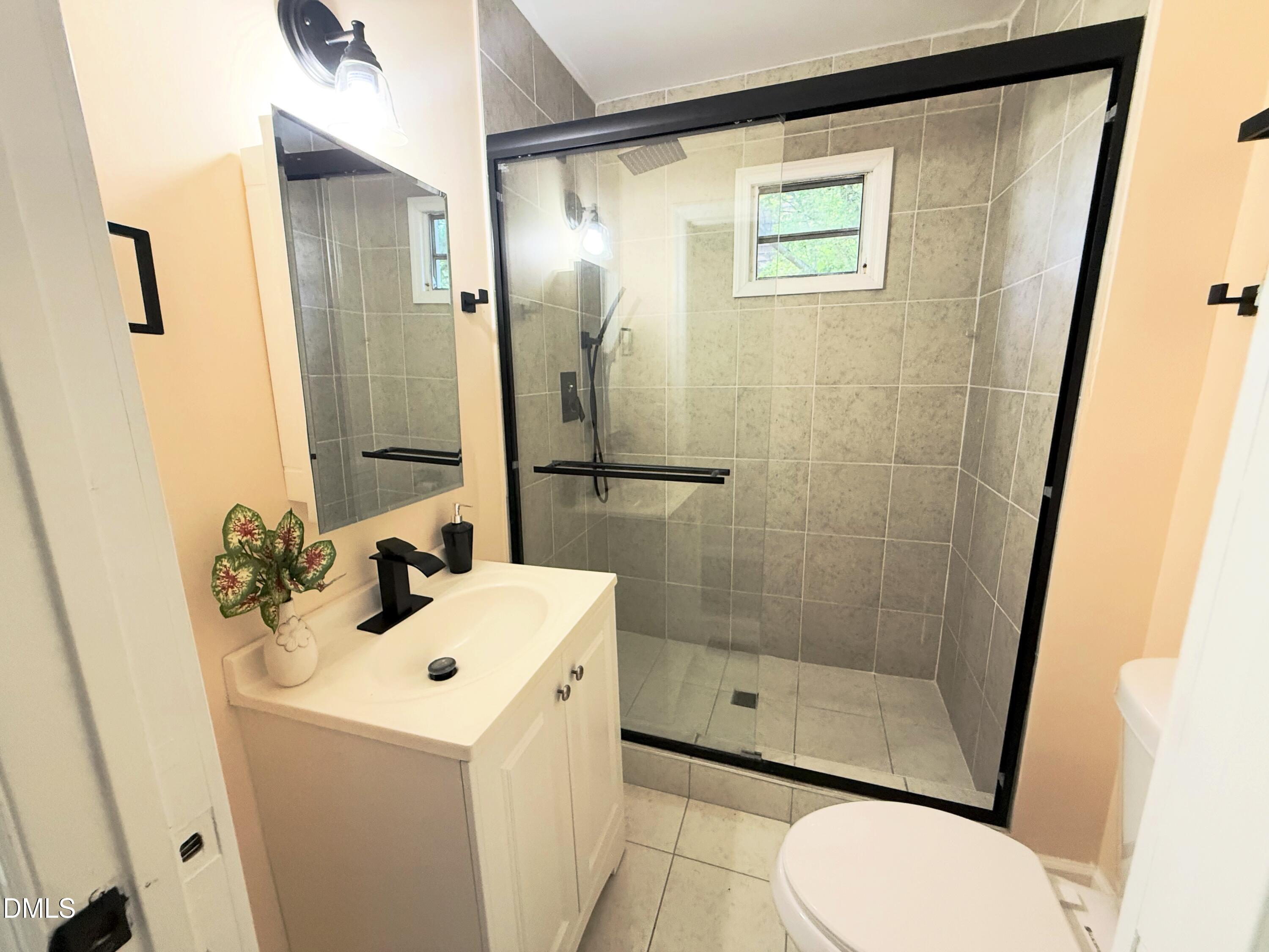 417 North Street Graham, NC 27253 - Photo 12 of 18 a bathroom with a sink a toilet and shower
