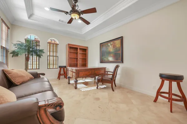 a living room with furniture a window and a flat screen tv