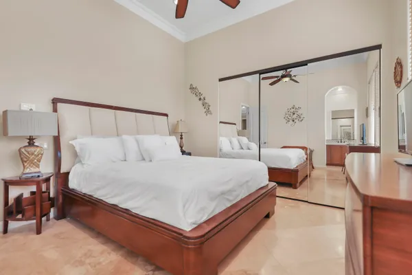 a spacious bedroom with a bed and window