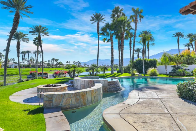 a view of a swimming pool and lounge chairs