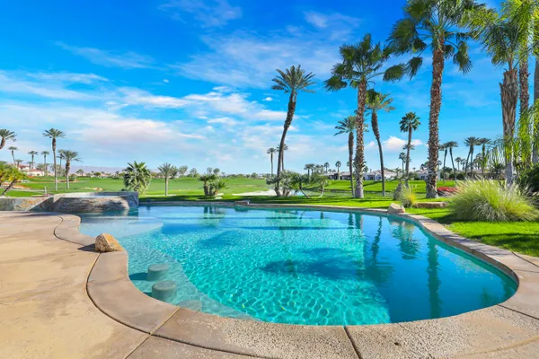 swimming pool view with a garden