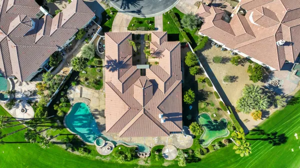 an aerial view of residential houses with outdoor space and street view