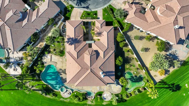 an aerial view of residential houses with outdoor space and street view